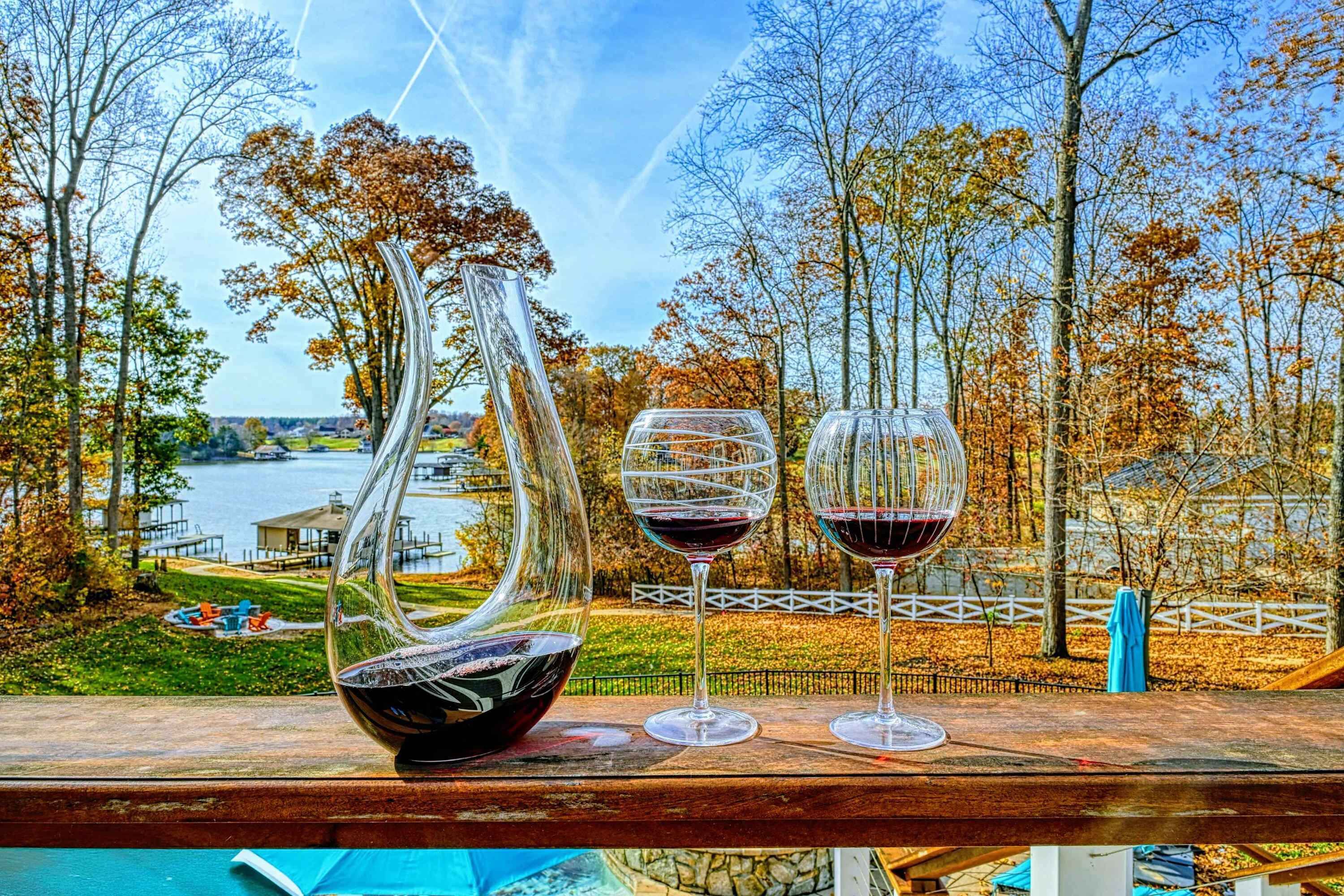 A table with a wine glass, a bowl, and a vase.