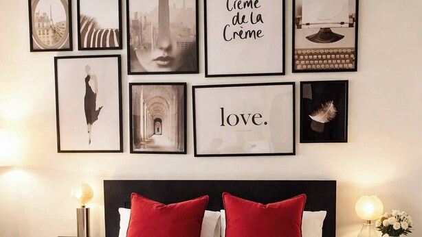 A neatly made bed with red and white bedding, a beige throw blanket, and framed artwork on the wall above. - Room-euro Edens Cosy Historic Home in Br (Brussels)