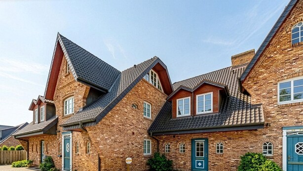 A row of brick houses with pitched roofs and multiple windows. - Senhuk - Senhuk part of the vacation home. With garden and terrace for up to 6 people. (Sylt)