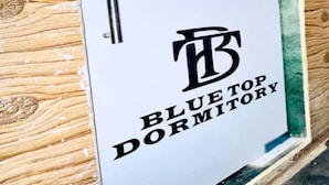 A door with the sign "Bluetop Dormitory" indicating a lodging facility. - Blue Top Dormitory (Mumbai)