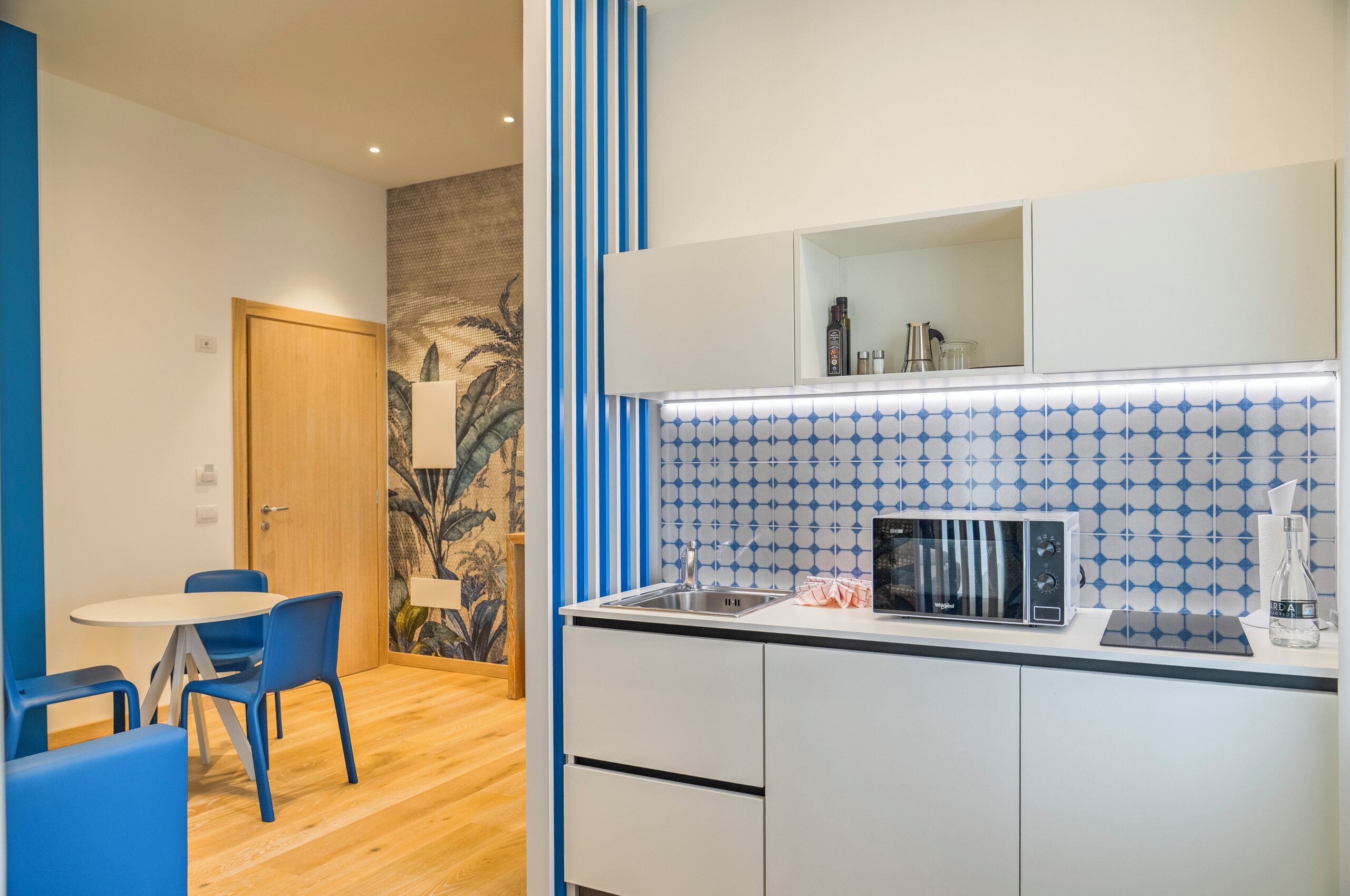 A compact kitchenette with a microwave, a coffee maker, and a small refrigerator.