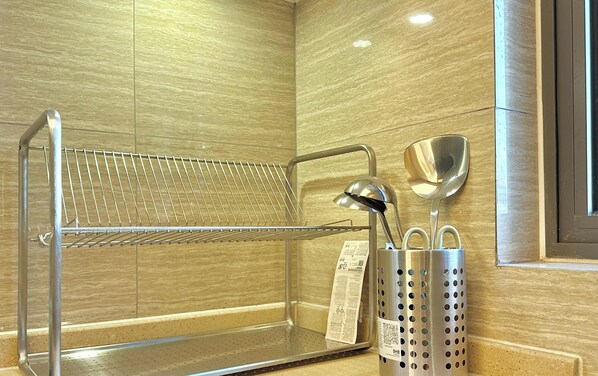 A bathroom with a metal rack, a handheld showerhead, and a towel dispenser. - R&F Princess Cove near CIQ by Stayrene (Johor Bahru)