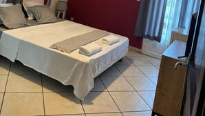 A hotel room with a large bed, a bedside table, a lamp, and a wardrobe. - Ylang Chambres d'Hôtes, Your Villa in Petite Terre, Mayotte (Dzaoudzi Labattoir)