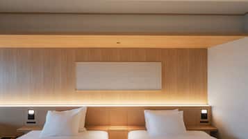 A hotel room with two beds, a wooden headboard, a wall-mounted artwork, and bedside lamps.