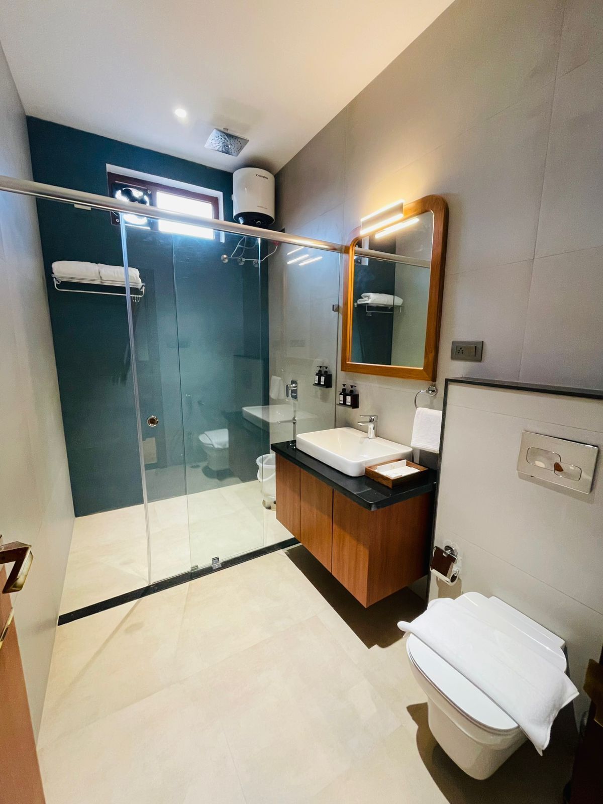 Shower, rainfall showerhead, slippers, towels