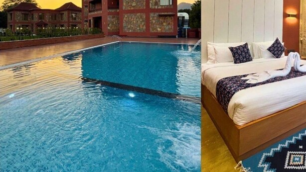 Un hôtel doté d’une piscine et d’une chambre comprenant un lit, des oreillers et un ventilateur de plafond.