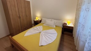A room with a bed, two bedside tables, a wardrobe, and a curtain. - Apartments Vista Bliss 3 (Crikvenica)