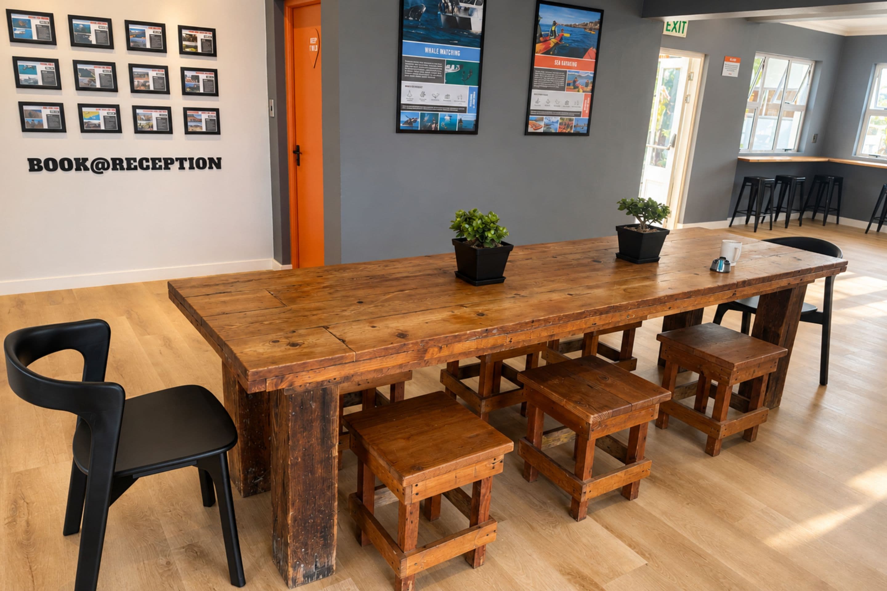 A reception area with a wooden reception desk, black chairs, and informational posters on the wall.