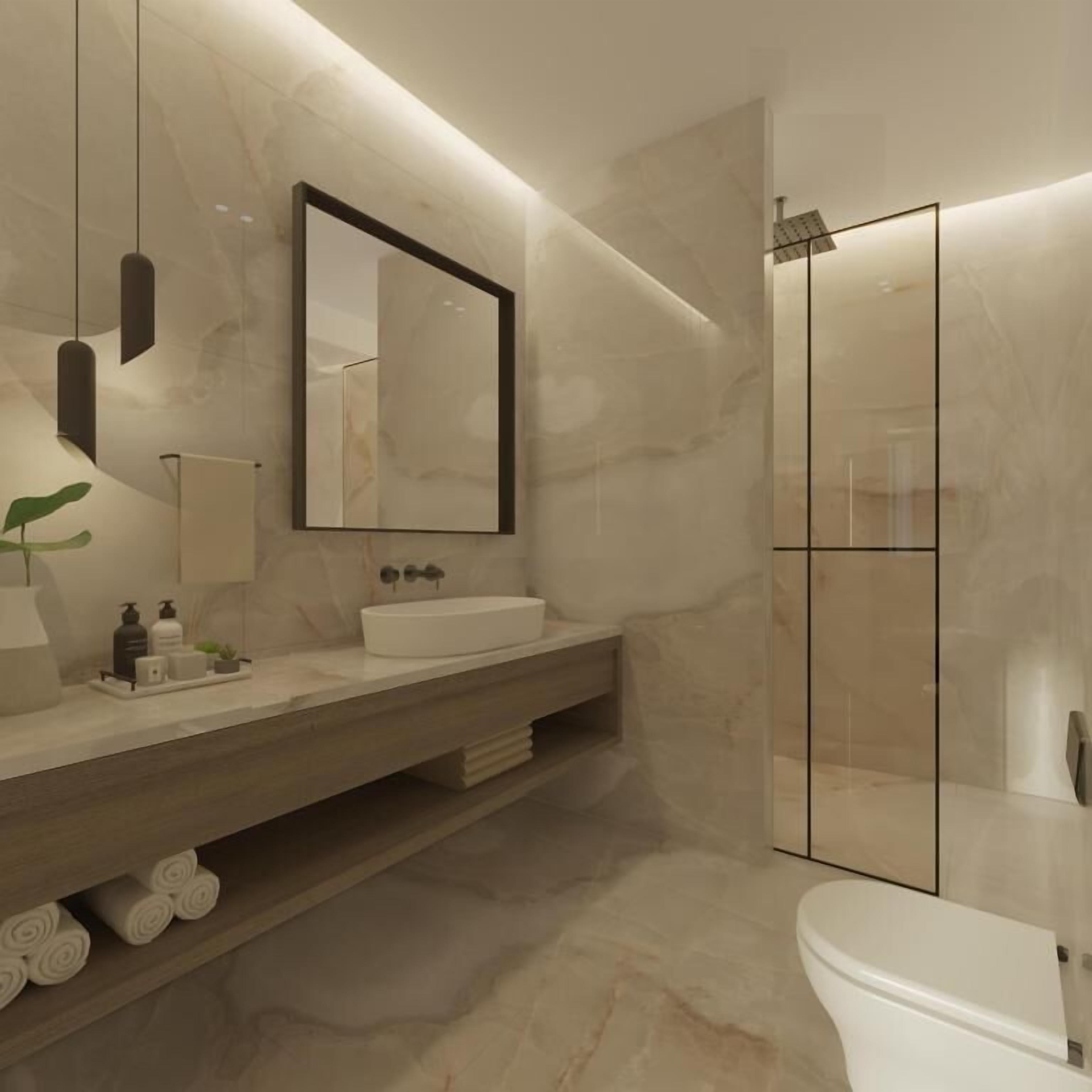 Un baño moderno con tocador de mármol, un espejo grande, cabina de ducha y un inodoro.