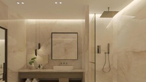 Un baño moderno con un espejo grande, un lavamanos y una ducha.