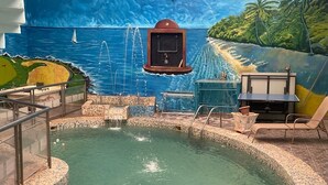 A swimming pool with a mural of a tropical beach and ocean. - Room-flexible 8-bedroom Luxury Apartment (Benin City)