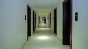 A long, well-lit hallway with doors on both sides leading to various rooms. - Villa Toscana Hotel Asaba (Asaba)