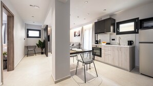 Eine moderne Küche mit Essbereich, ausgestattet mit Backofen, Mikrowelle und einem großen Fenster über der Spüle.