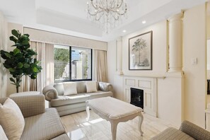 TV, fireplace, books - The Residence on Swan – Absolute Riverfront Family Luxury with City Views (Maylands)