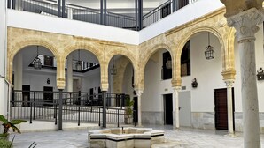 Un patio amplio con varios arcos y una zona de estar central.
