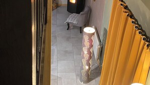 A cozy room with a fireplace, a sofa, and a curtain. - Cozy vacation rental for 6 people, with a garden in Normandy, near the D-Day beaches (La Luzerne Manche)