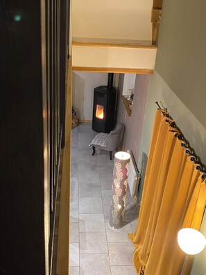 A cozy room with a fireplace, a sofa, and a curtain. - Cozy vacation rental for 6 people, with a garden in Normandy, near the D-Day beaches (La Luzerne Manche)