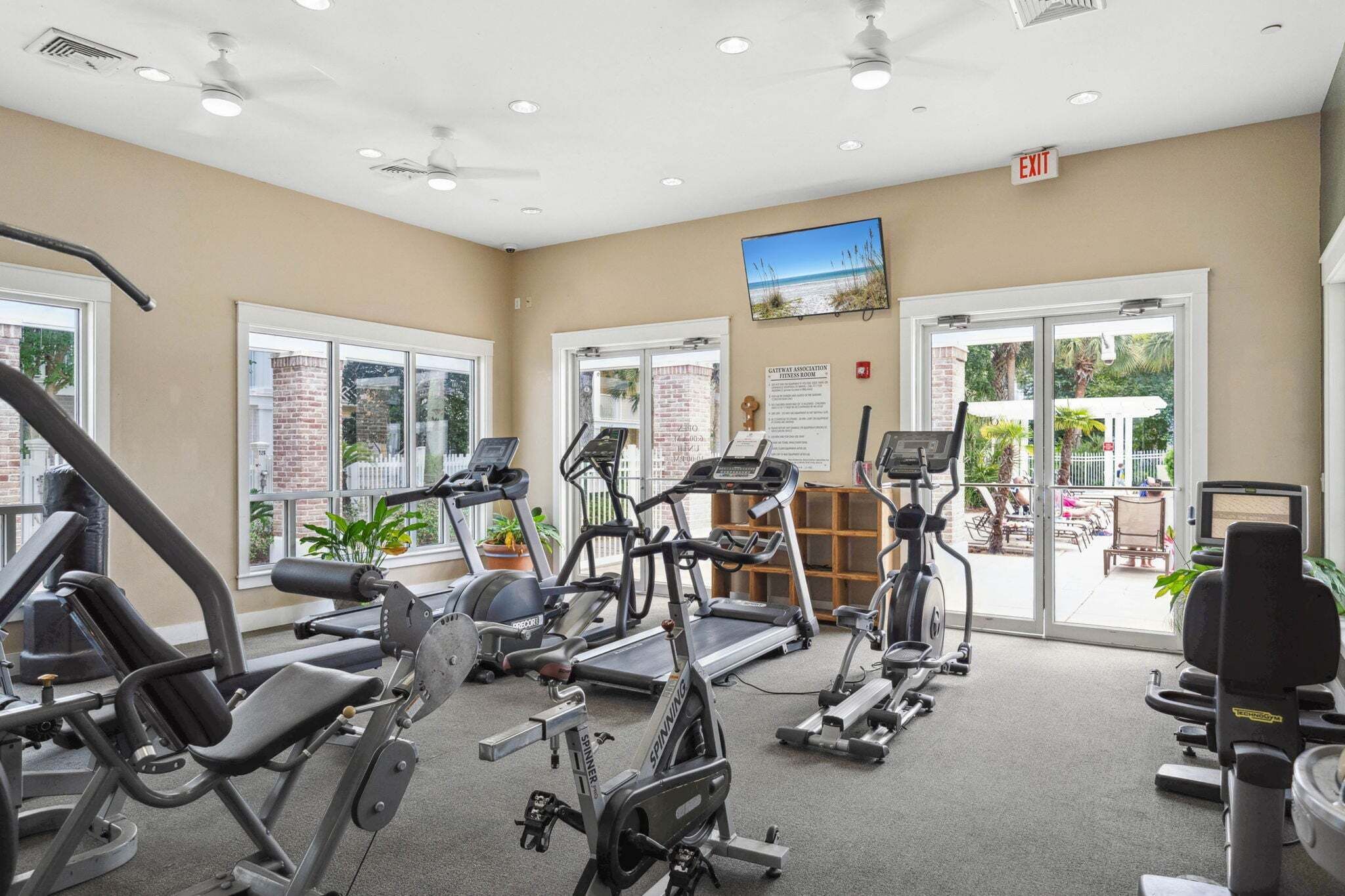 A gym with treadmills, elliptical machines, and weight machines.
