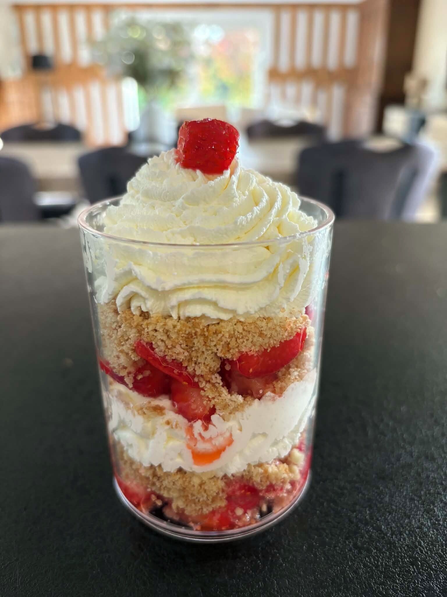 A dessert in a clear glass container.