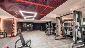A gym with weightlifting equipment, treadmills, and a bench press. - Stayshort - Stunning 1 Bed Bedroom in JVT That Sleeps 2 (Dubai)