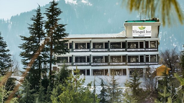A multi-story building with a sign for 'The Tranquil Inn Manali'. - The Tranquil Inn (Manali)