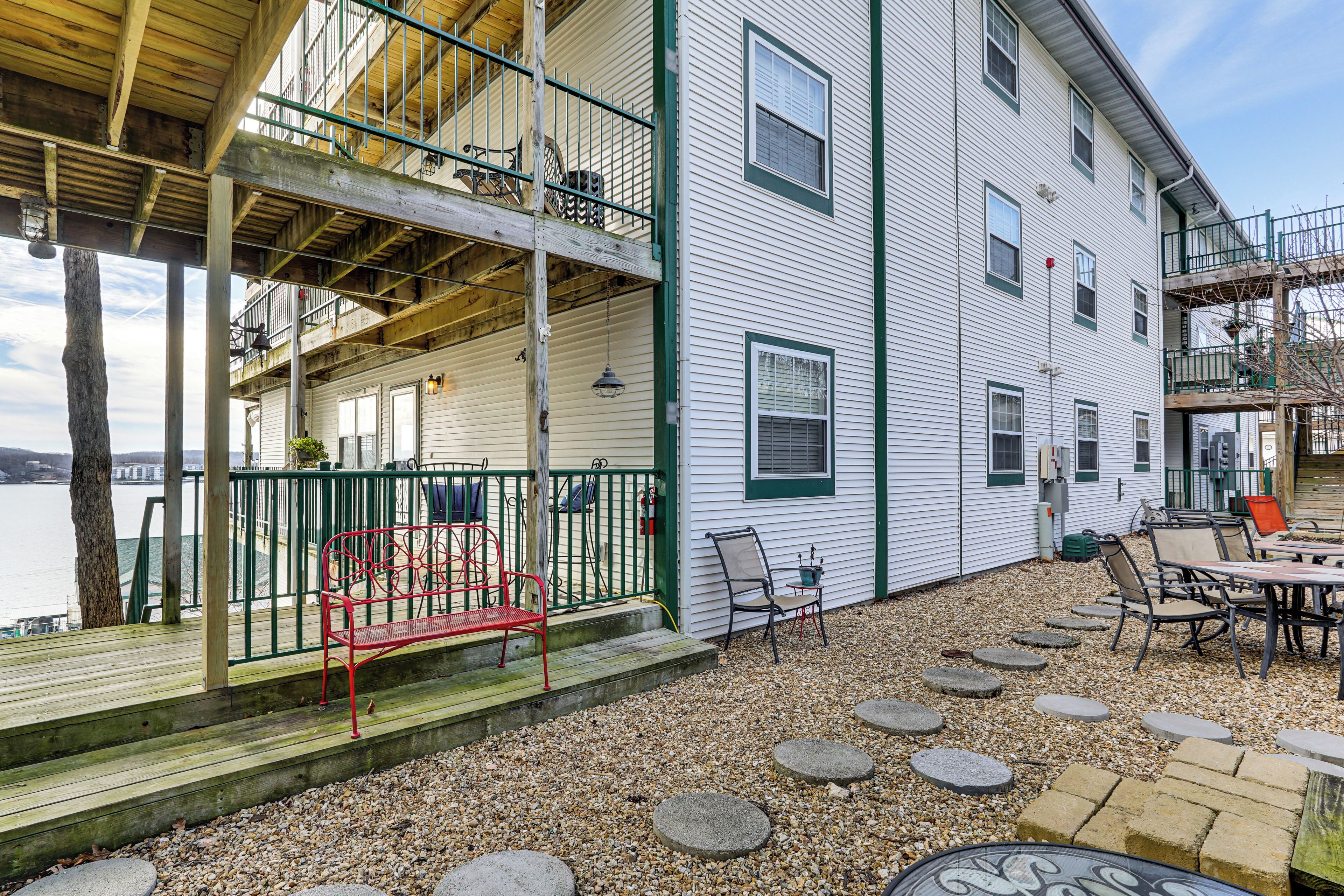 A two-story building with a covered deck and outdoor seating area.