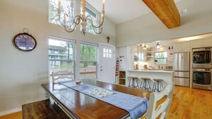 A spacious kitchen with a wooden island, stainless steel appliances, and a chandelier. - Dock + Fire Pit: Tranquil Home on Lake Livingston (Livingston)