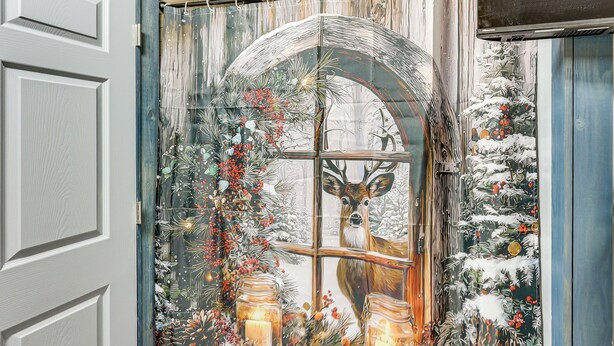 A room with a large window featuring a deer and winter scene. - Gym Access On-site: Cabin w/ Deck in Red Oak! (Red Oak)