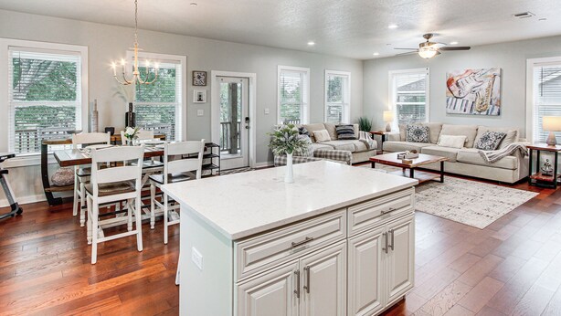 A spacious living area with a kitchen island, dining table, and seating arrangement. - Steps to Sand! Family-friendly Long Beach Escape (Long Beach)