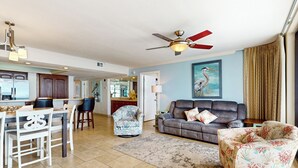 A spacious living area with a dining table, chairs, a sofa, and a ceiling fan. - 3BR Gulf-view Resort Condo: Suntide III - Unit 605 (South Padre Island)