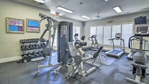 A gym with various exercise equipment, including dumbbells, treadmills, and weight machines. - Golf Cart & Pool Access! Condo in Myrtle Beach (Myrtle Beach)
