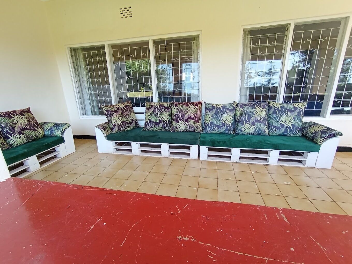 A seating area with a sofa set and a red table.