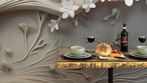 A dining table with a floral wall mural, a bottle of wine, and a loaf of bread. - Classic APT with Internal Court Yard (Valletta)