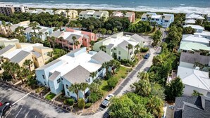 A coastal residential area with colorful houses, a parking lot, and a view of the ocean. - Quail Hollow A8-1u 2 Bedroom Condo (St. Augustine)