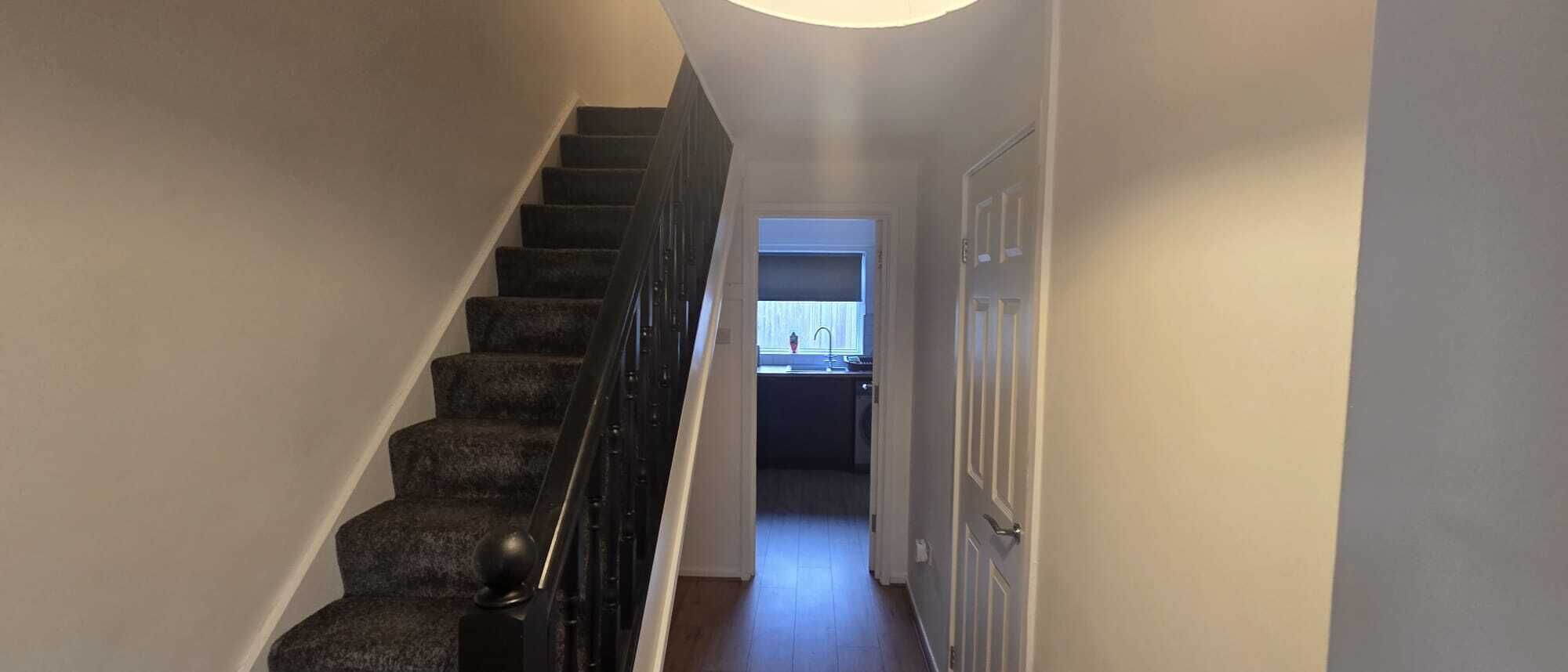 Bright entrance hallway with stairs - welcoming and well-lit property with easy access to all rooms