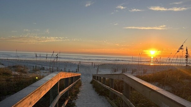 A wooden boardwalk leading to a beach at sunset. - Ocean Village Club I35: Pool & Ocean Views 2 Bedroom Condo (St. Augustine)