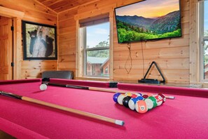 A pool table with balls and cues, a television displaying a landscape, and a framed picture of a bear. - Handicap Friendly Cabin Retreat・Pool Table・Grill (Pigeon Forge)
