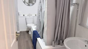 Een haardroger, handdoeken, zeep, toiletpapier