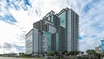 A multi-story building with a modern architectural design, featuring a mix of glass and concrete facades.