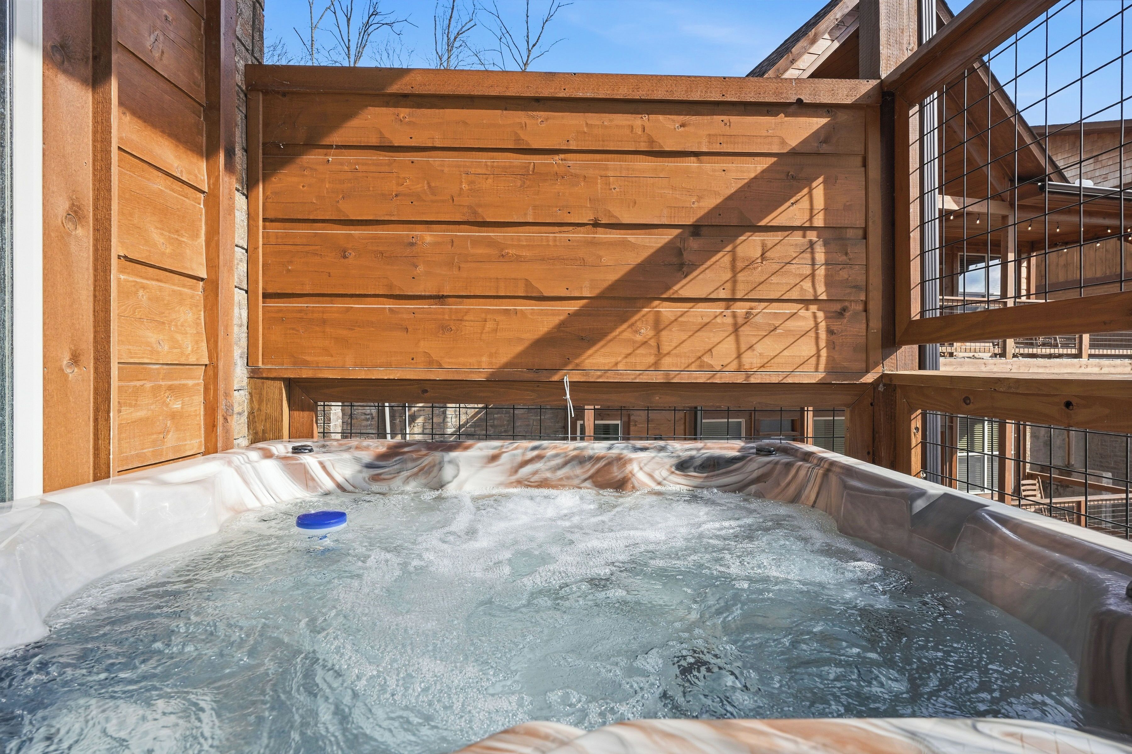 A wooden cabin with a hot tub.