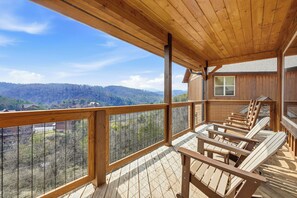 A wooden deck with a view of a mountainous landscape. - Indoor Pool, Hot Tub & Mountain Views, Arcade Games and Free attractions (Sevierville)