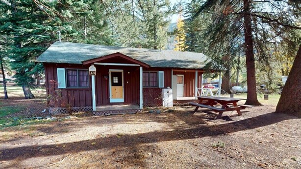 A cabin with a porch, a picnic table, and a sign indicating the number 43. - Cozy Frances Lake Retreat | Wallowa Lake Fun (Joseph)