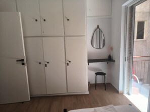 A room with a wardrobe, a mirror, a small stool, and a window. - Casa Dili Stylish 2BR Apartment (Athens)