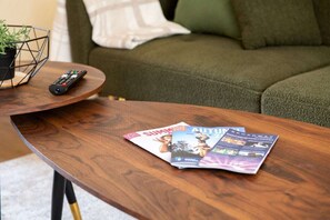 A wooden coffee table with magazines and a remote control. - Rosewick Villa wt Office, Garden & Free Parking (Nottingham)