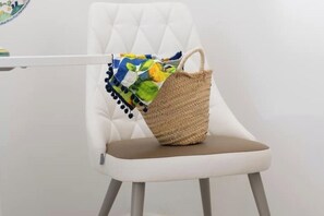 A white upholstered chair with a woven bag placed on it. - Villa Guarracino Luxury with private hot tube (Amalfi)