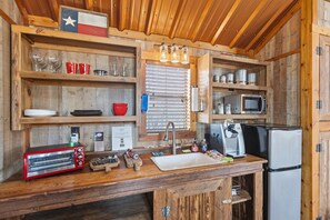 Fridge, microwave, coffee/tea maker, cookware/dishes/utensils