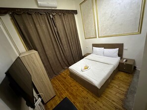 A hotel room with a bed, bedside table, and a wardrobe. - Yacoubian Hotels (Cairo)