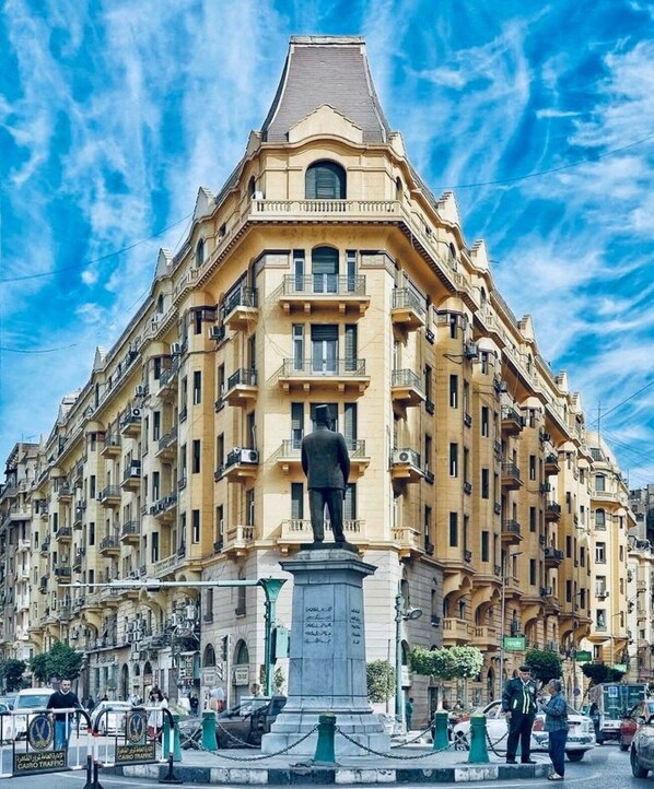 A large building with a statue in front. - Yacoubian Hotels (Cairo)