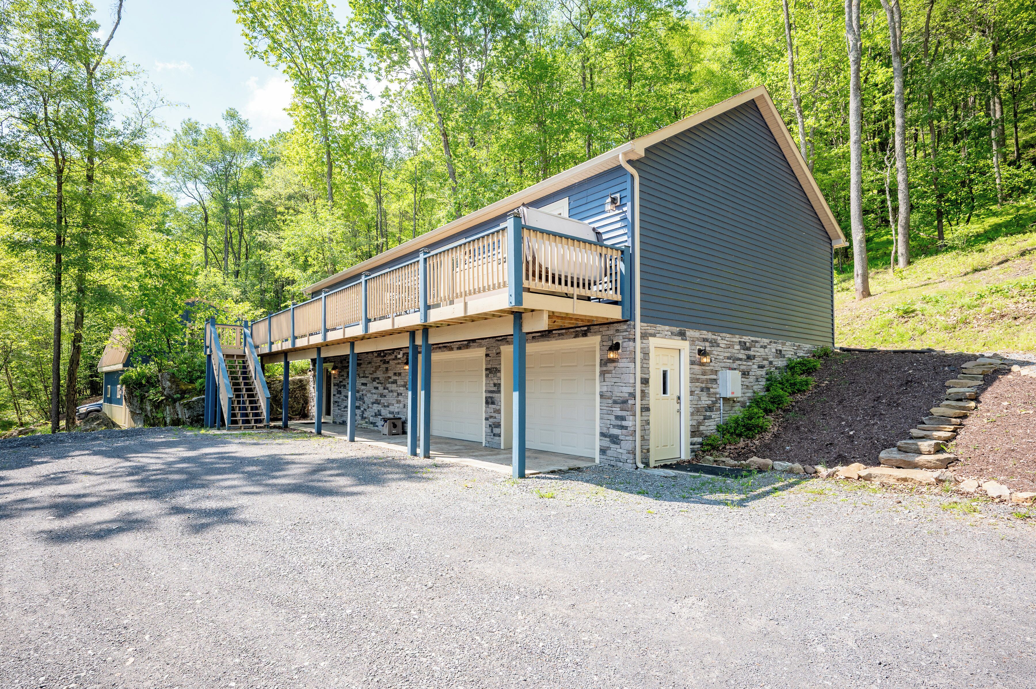 A two-story building with a covered porch and a garage.