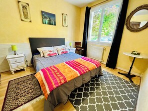 A bedroom with a bed, bedside tables, a window with curtains, a mirror, and a small table. - Beautiful "Keristin" family home in Concarneau (Concarneau)